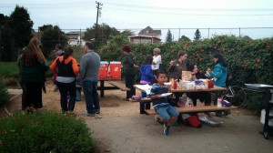 People gather at the potluck tables, offering conversation and a breather.