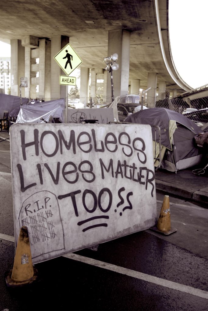 A large "Homeless Lives Matter??" sign camp residents built to shield themselves from traffic. 