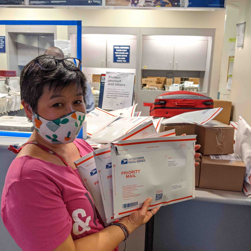 Photo: Kimi Lee dropping off packages for shipping at the USPS 