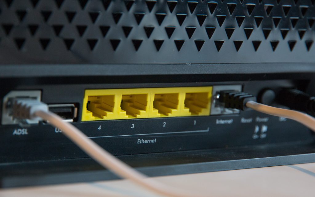 A closeup image of a router with two ethernet cords.