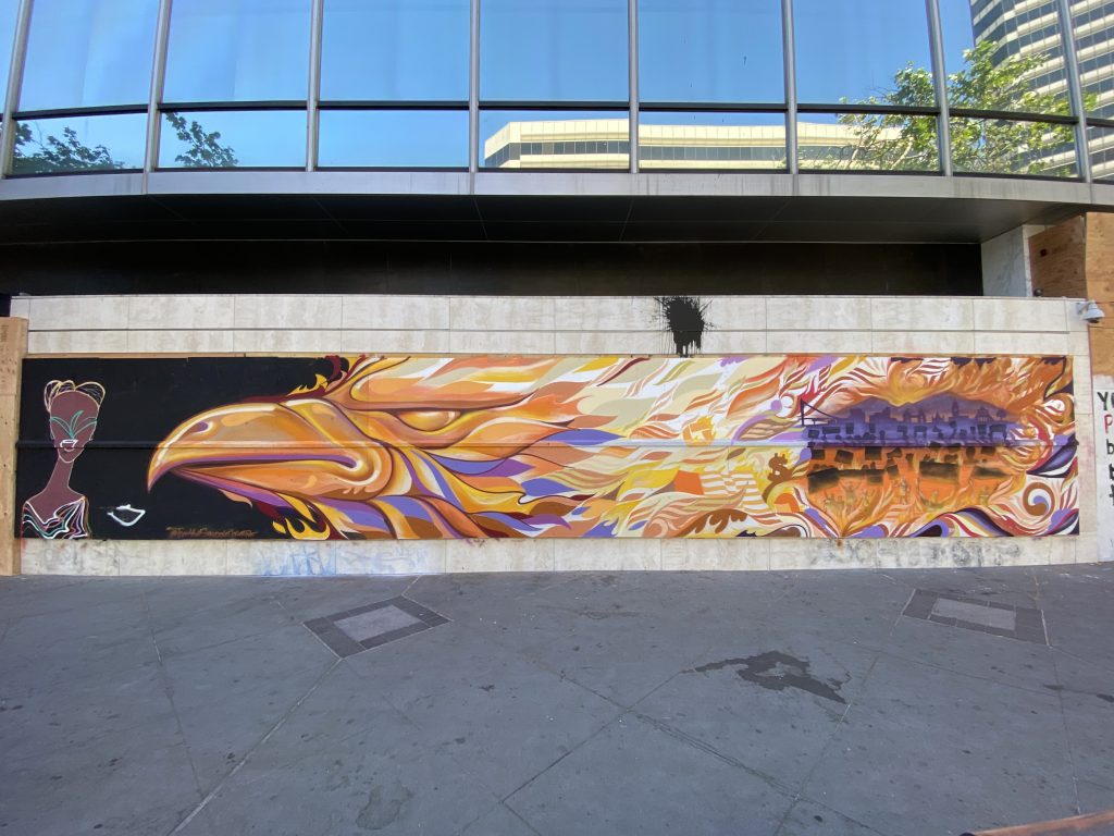 A large mural with an eagle in fire orange colors.