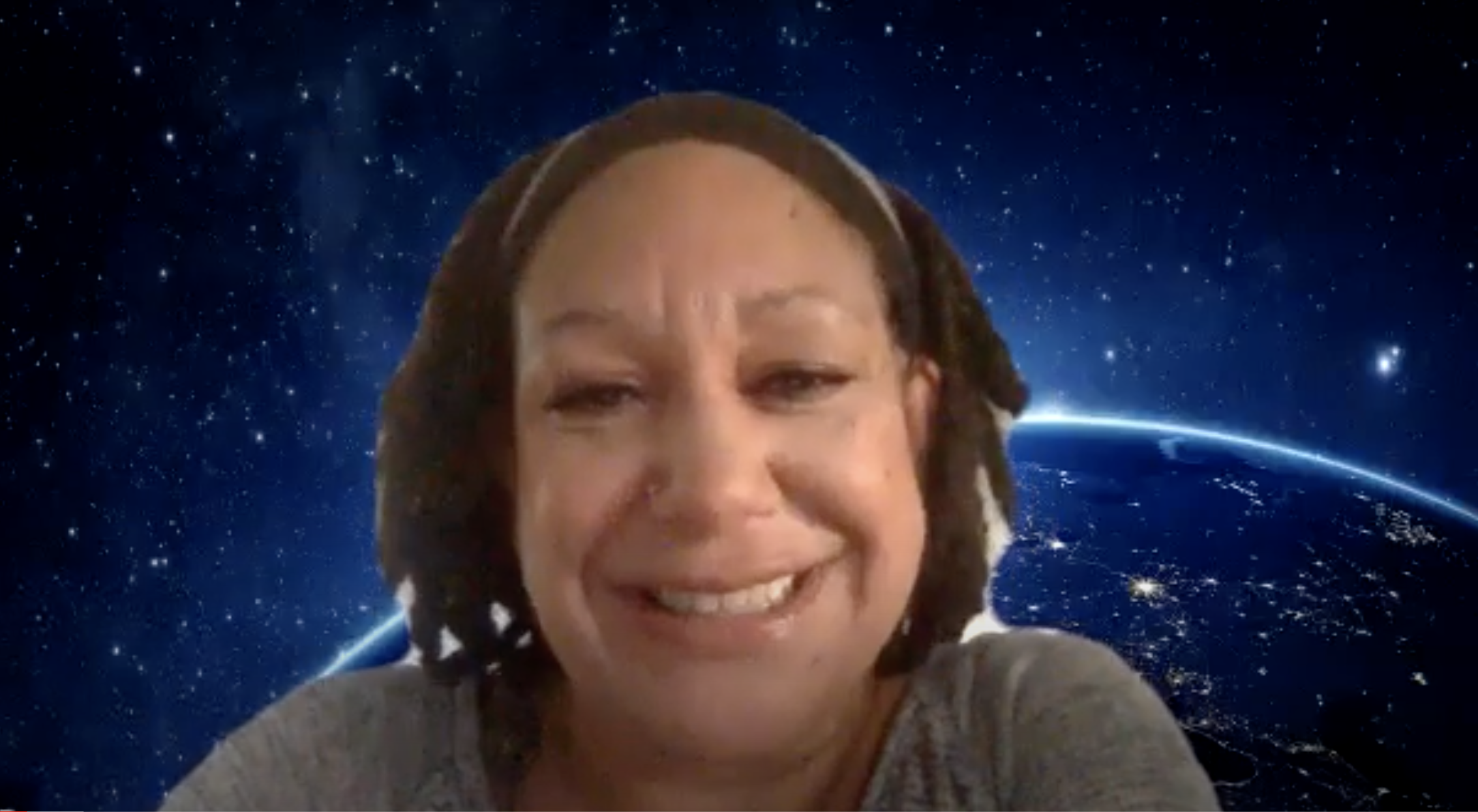 An African American woman is on a Zoom webinar with earth and outer space as the background.