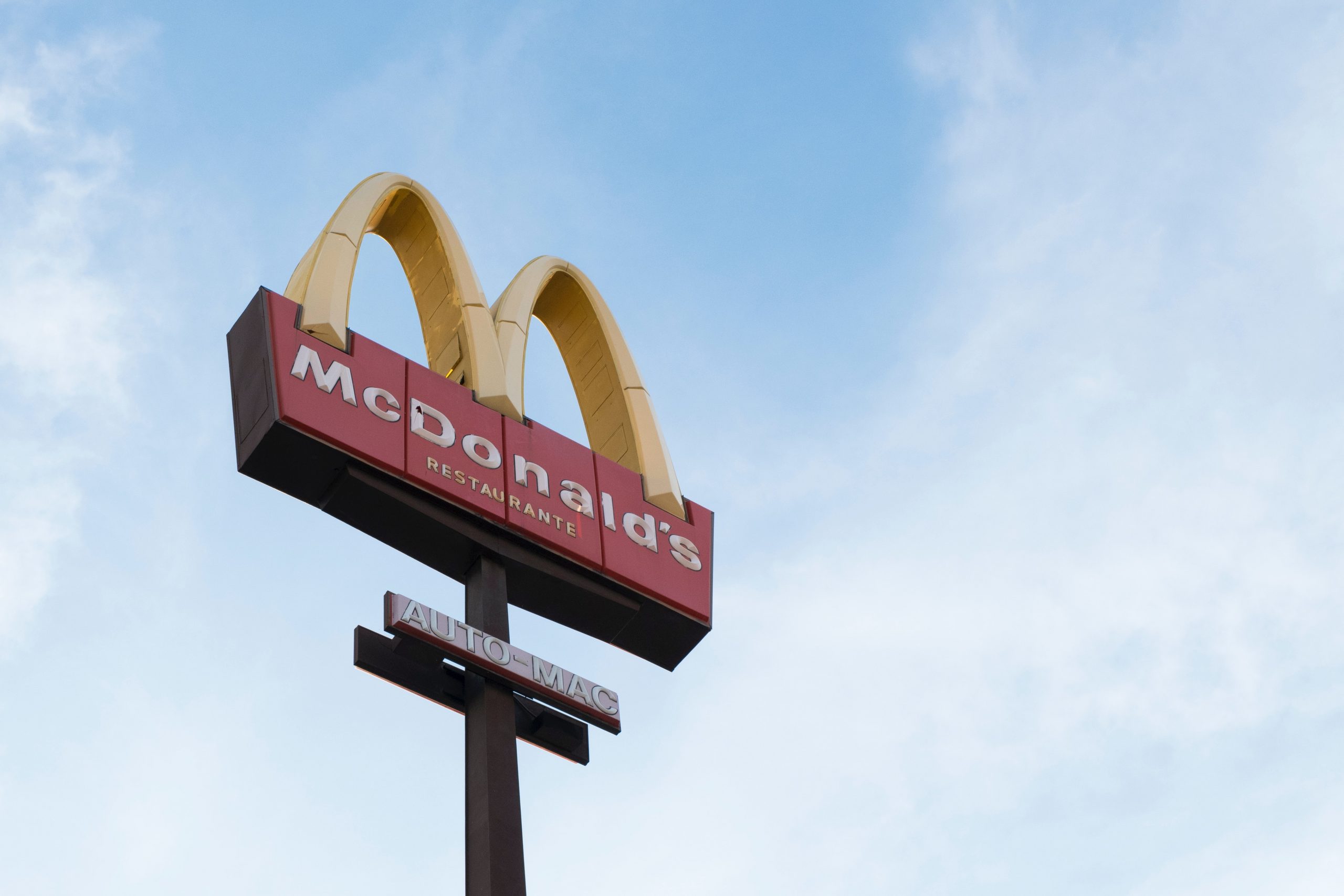The McDonald's sign against the blue sky.