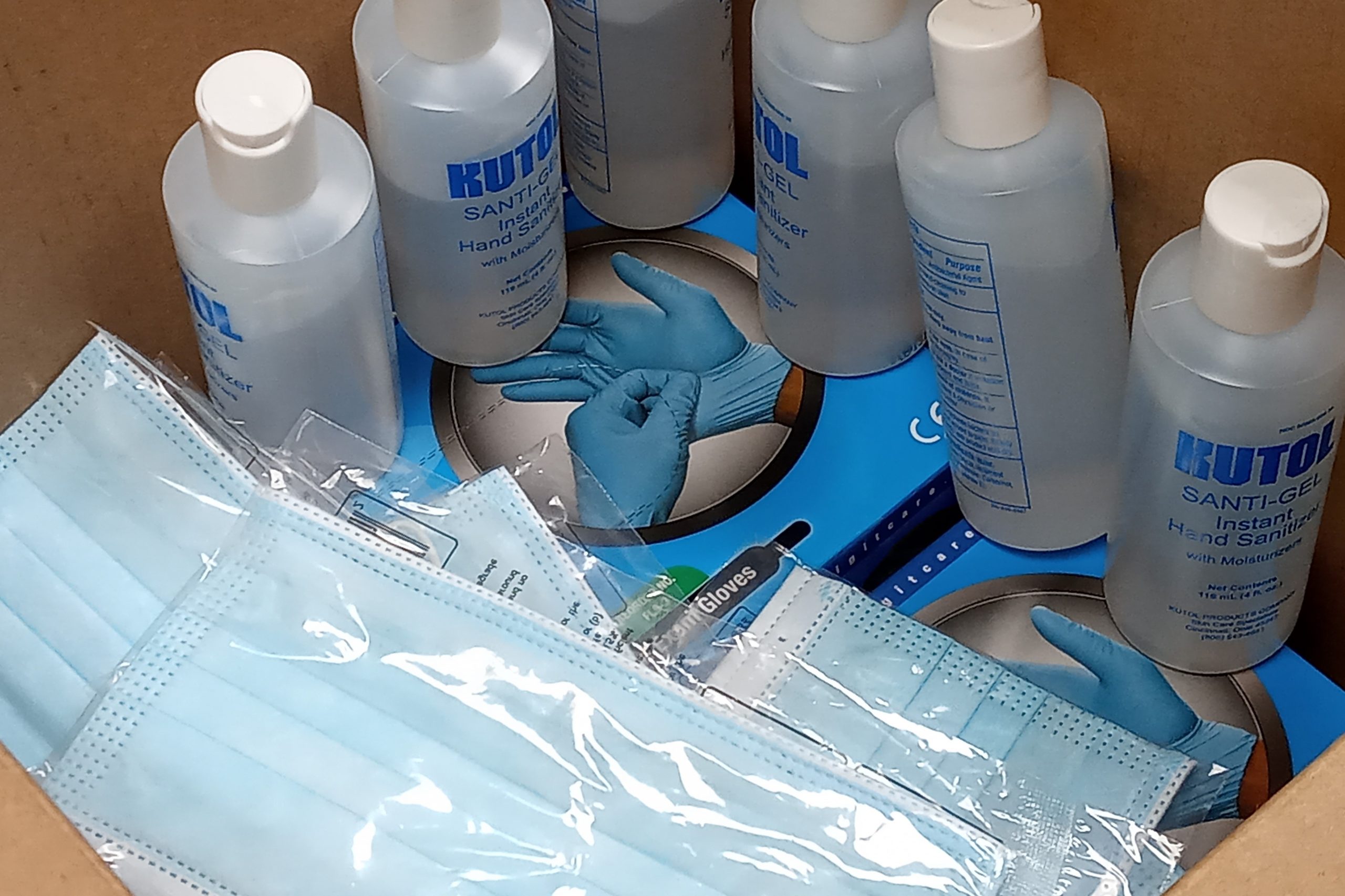 A photo of surgical masks, hand sanitizer, and gloves