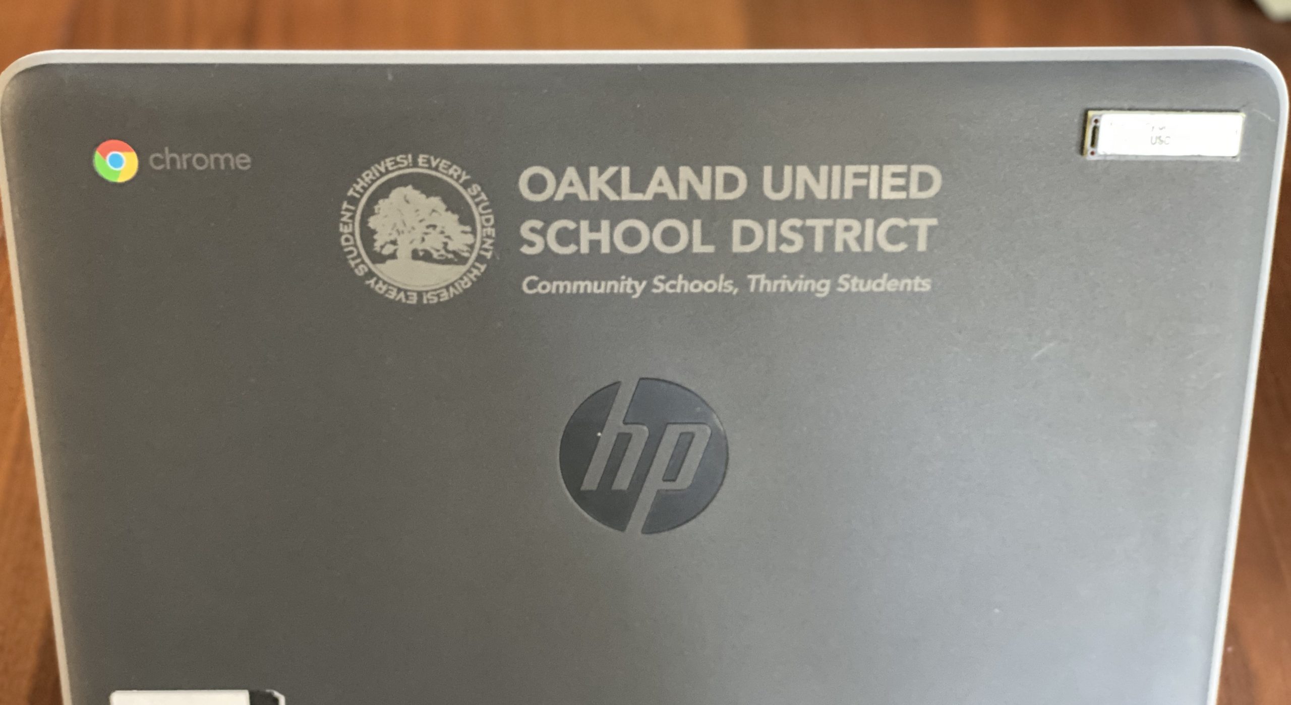 An image of a grey Chromebook laptop with OUSD engraved on it.