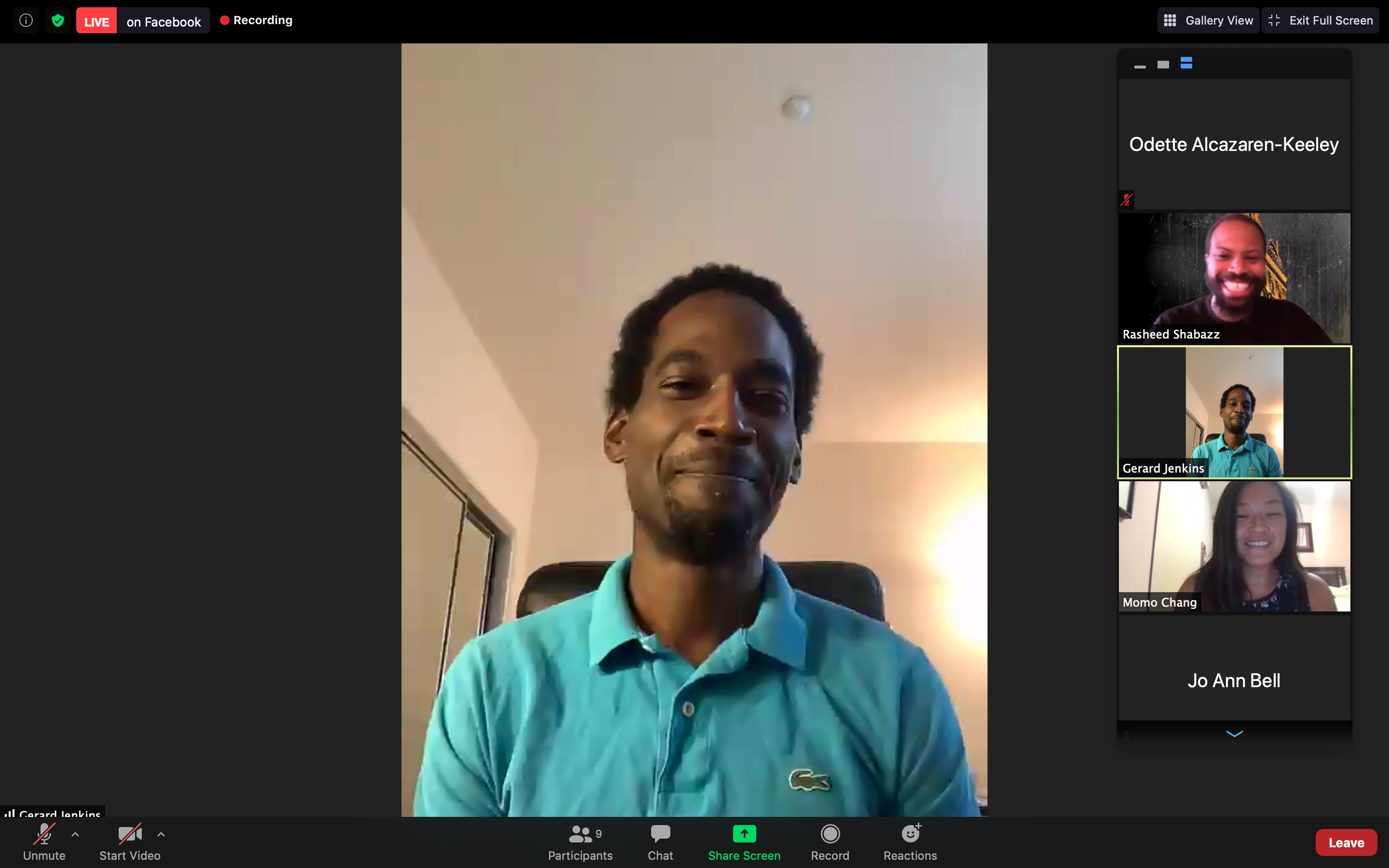 An African American man wearing a turquoise shirt speaks on a Zoom presentation.