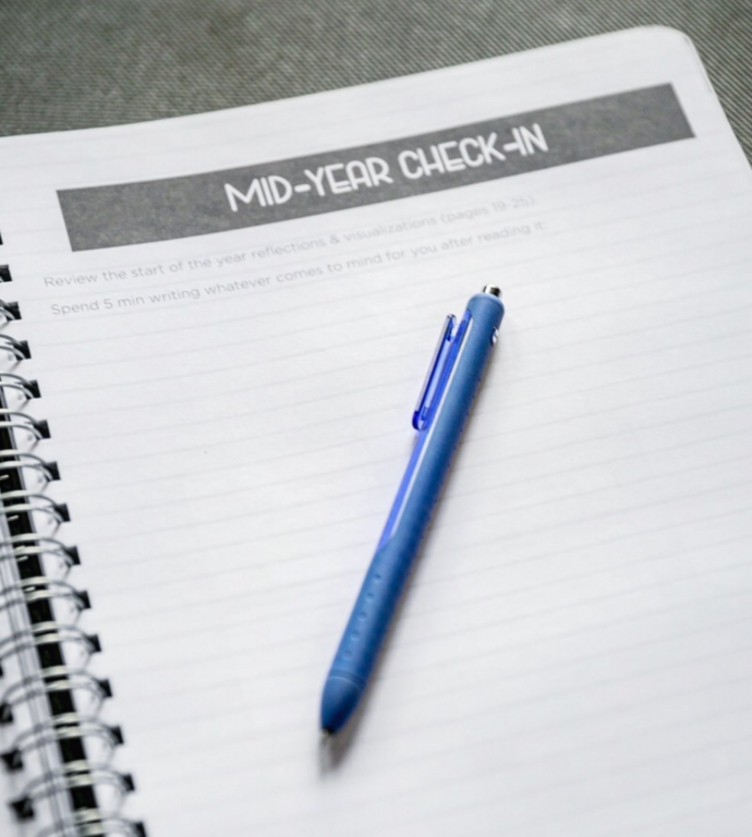 An image of a notebook that says "mid-year check-in" at the top.