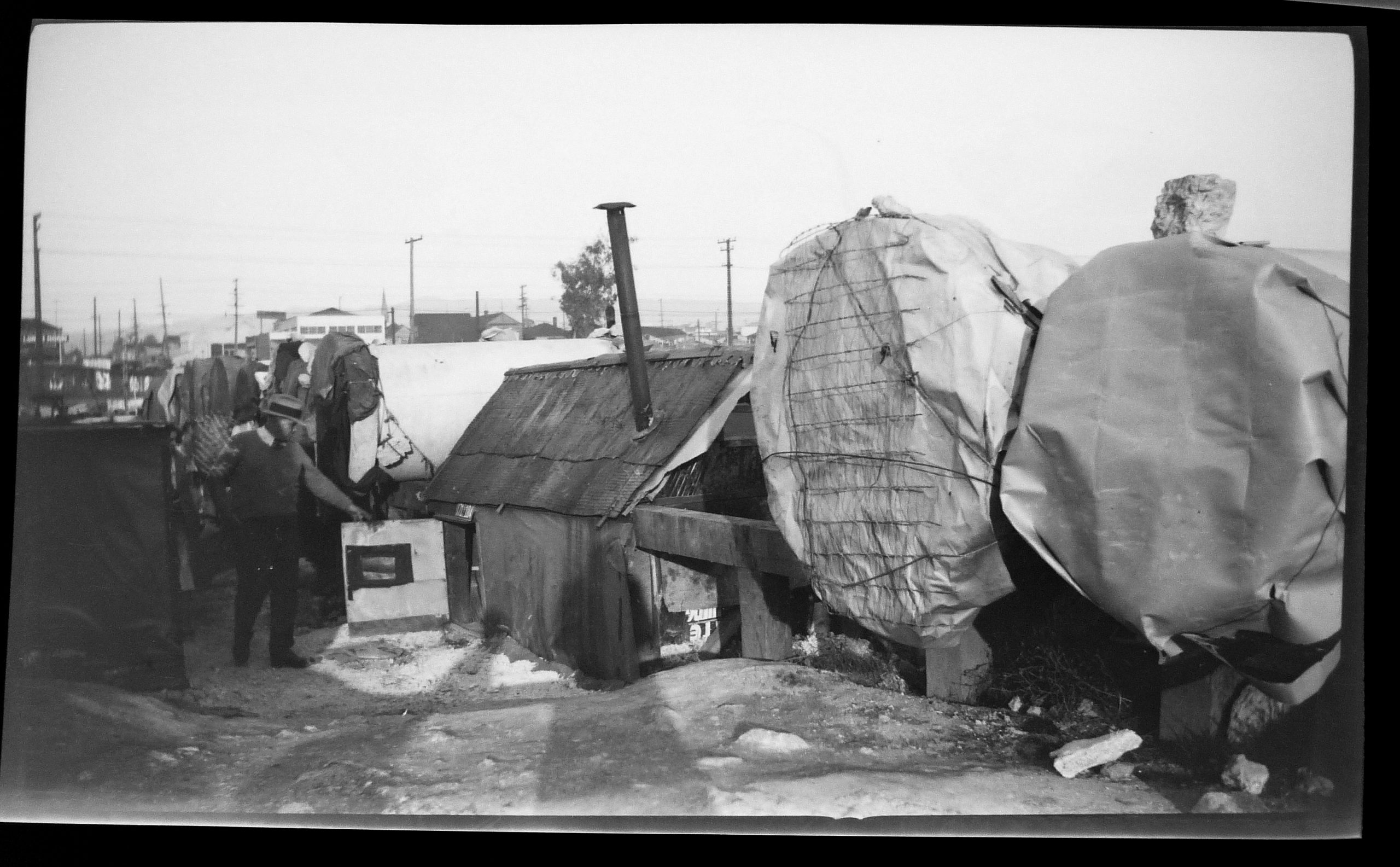 black and white image of tents set up in the early 1930s in Oakland, dubbed "Pipe City"