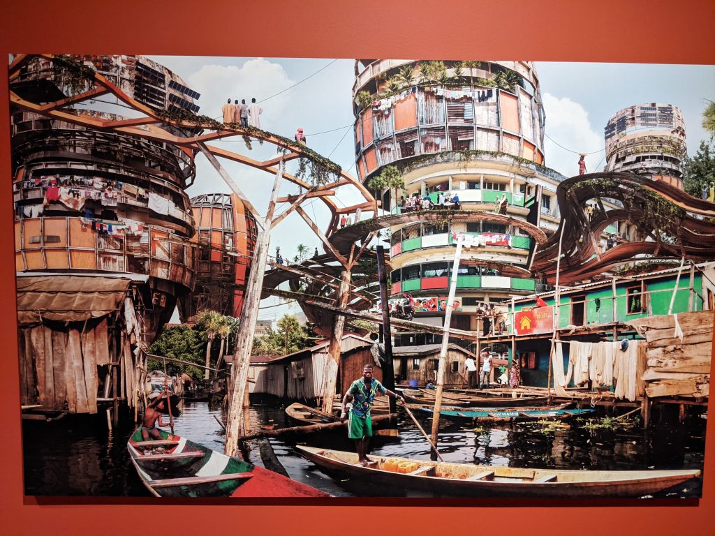 A photo of a large image of shanties and color structures by artist Olalekan Jeyifous.