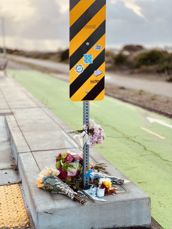 an intersection where flowers are laid on the concrete 