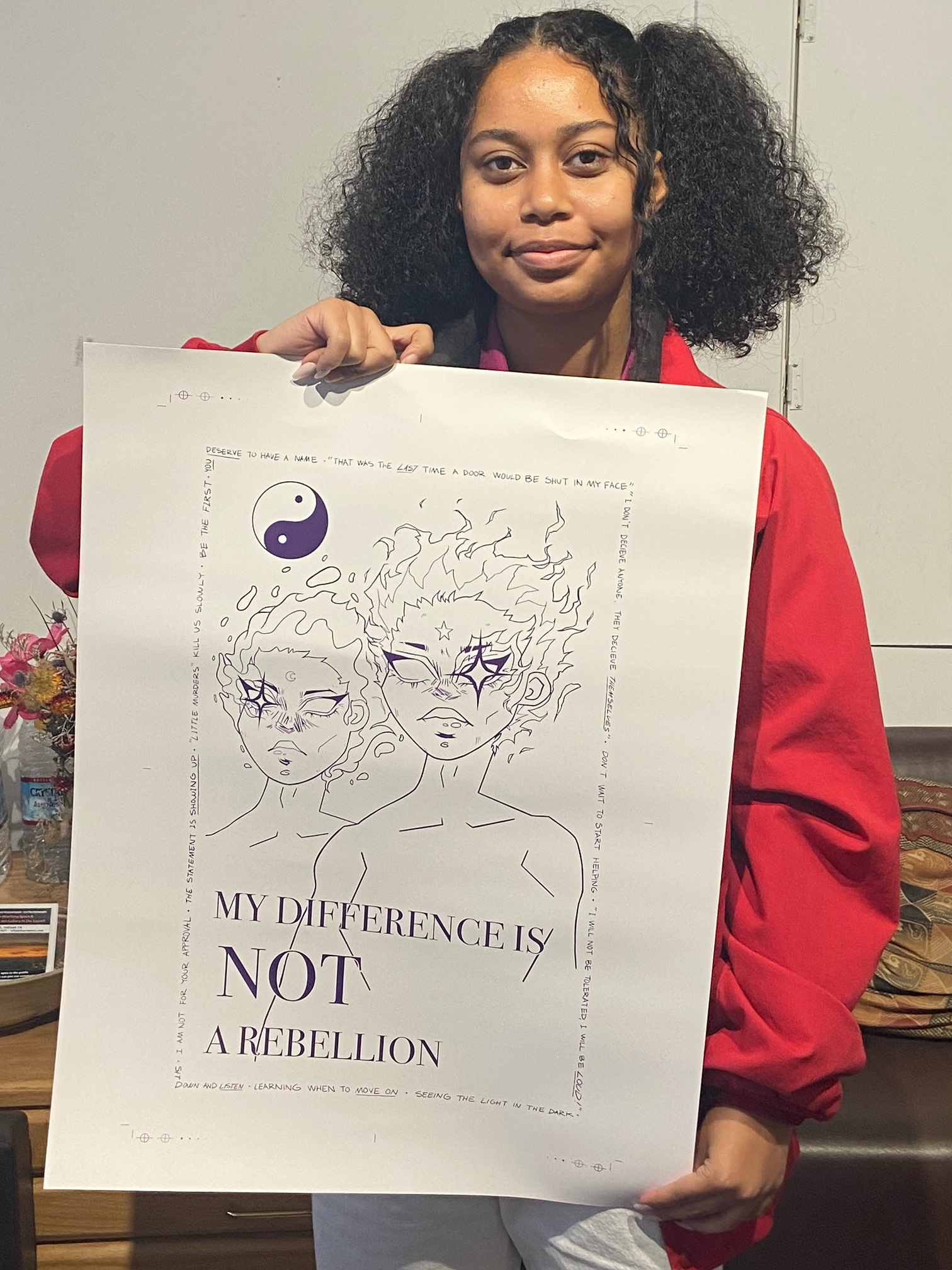 an image of an African American girl smiling while holding a poster drawing that she created