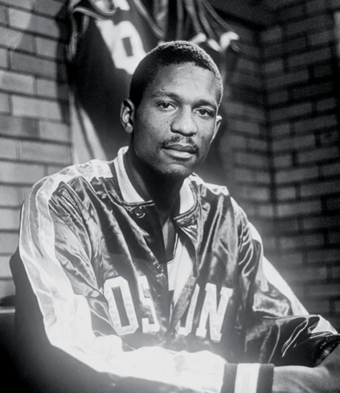 black and white photo of African American man wearing a Boston Celtics jacket