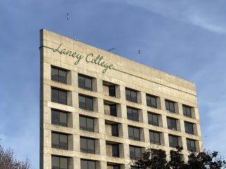 A concrete building with the words "Laney College" in green letters at the top