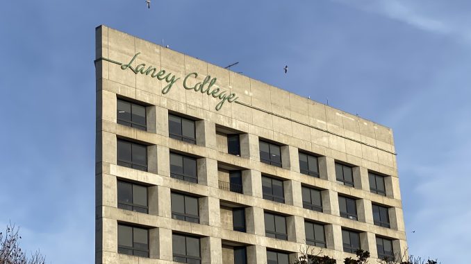 A concrete building with the words "Laney College" in green letters at the top