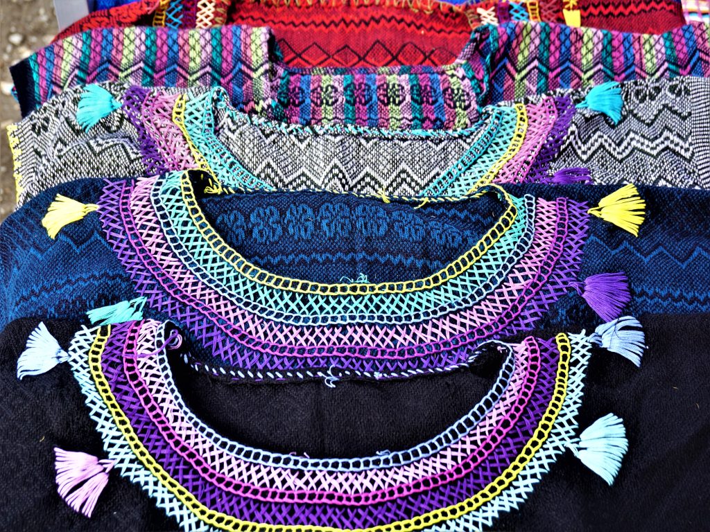 close up of beaded collars of colorful clothes