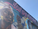 A colorful mural with "You are beloved" and Harriet Tubman and others