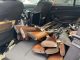 inside a police car, you see a bunch of metal and wooden handled rifles in the backseat