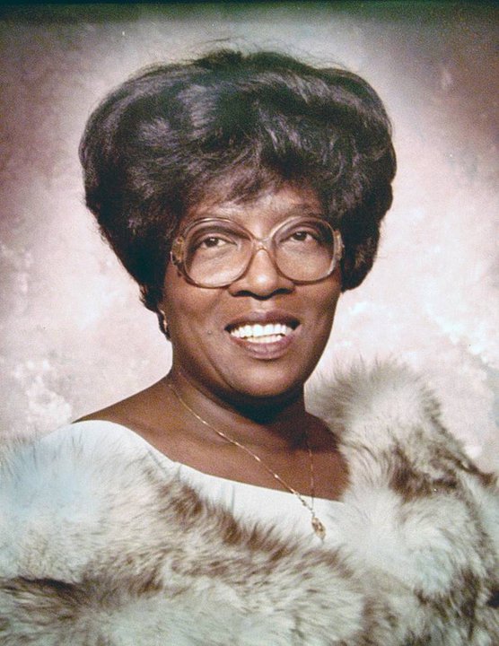 A portrait photo of a Black woman wearing glasses, circa 1978