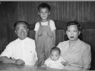 black and white photo of three Chinese American men eating inside a Chinese restaurant